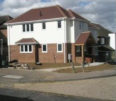 Newly built detached house with white render and brick