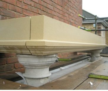 Restored stone cornice above a column